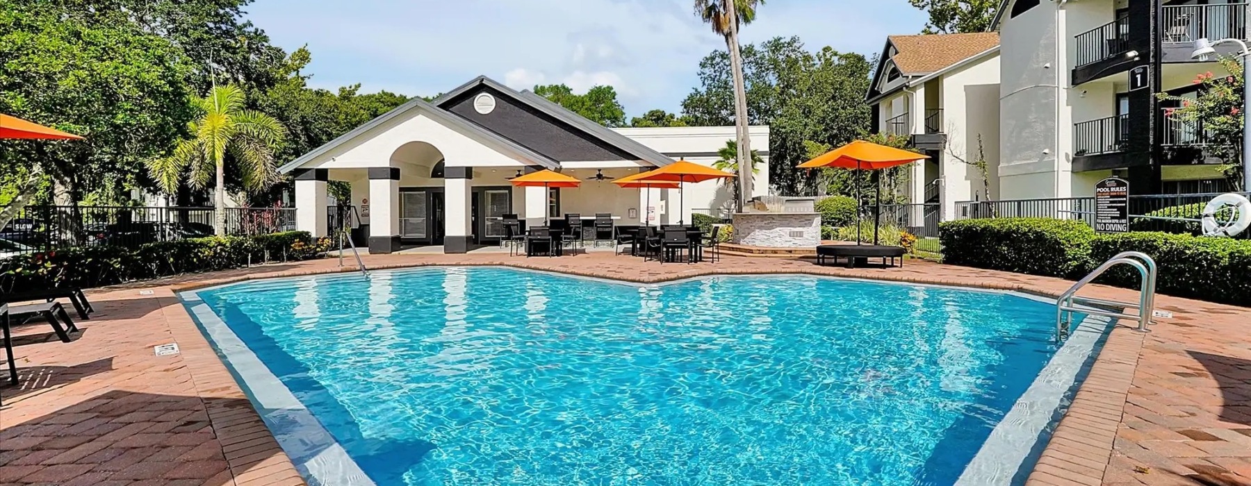 Resort-style swimming pool with lounge seating