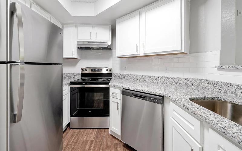 a kitchen with white cabinets