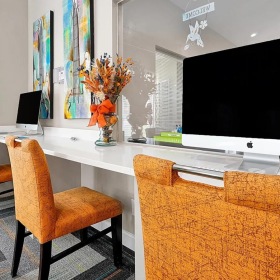 a long desk with computers on it